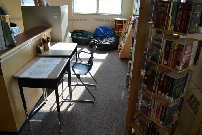 Inside photo of Sachigo Lake First Nation library featuring books shelves and desks.