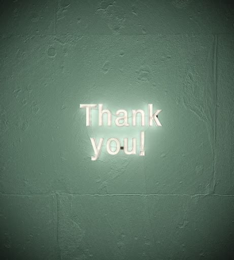 "Thank you" written on a wall.