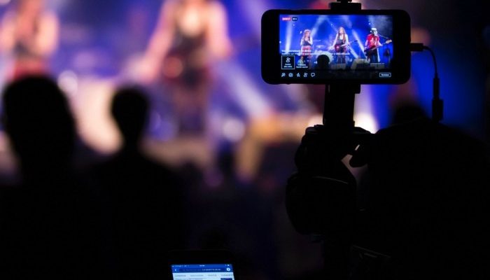 A Picture Of A Cell Phone Streaming A Live Concert