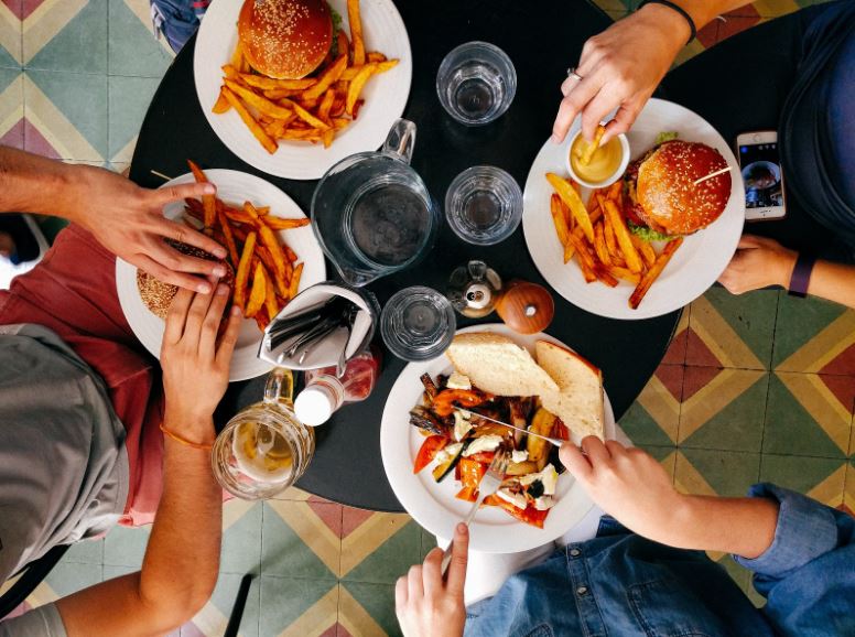 Overhead shot of four people eating hamburgers