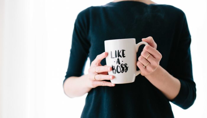 Woman Standing With A Mug That Reads Like A Boss