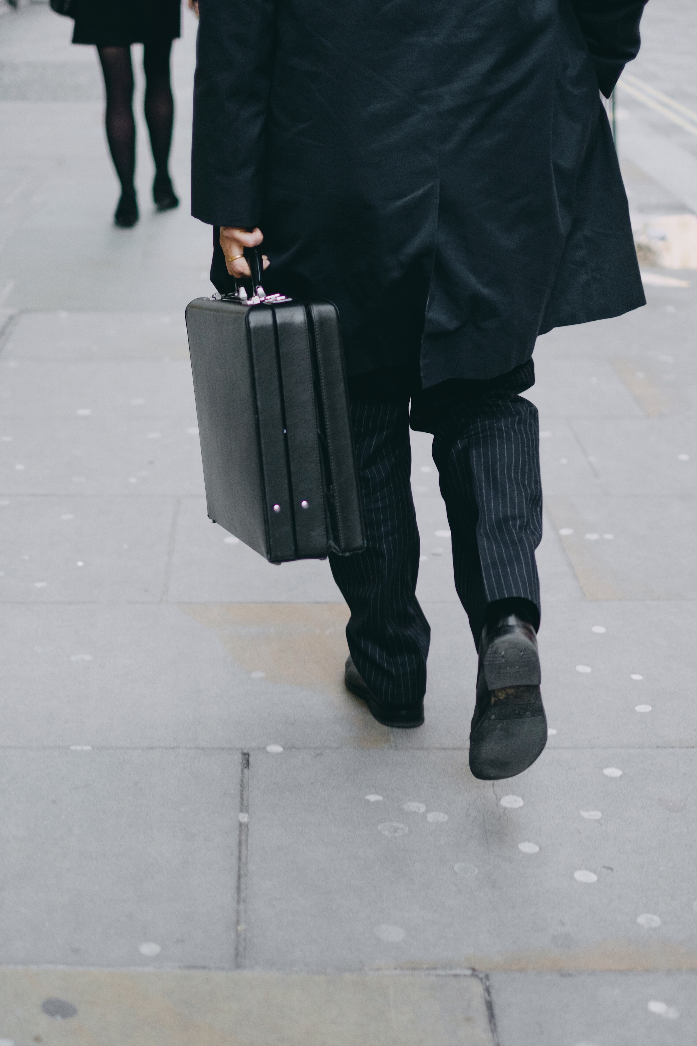 Person walking with briefcase.