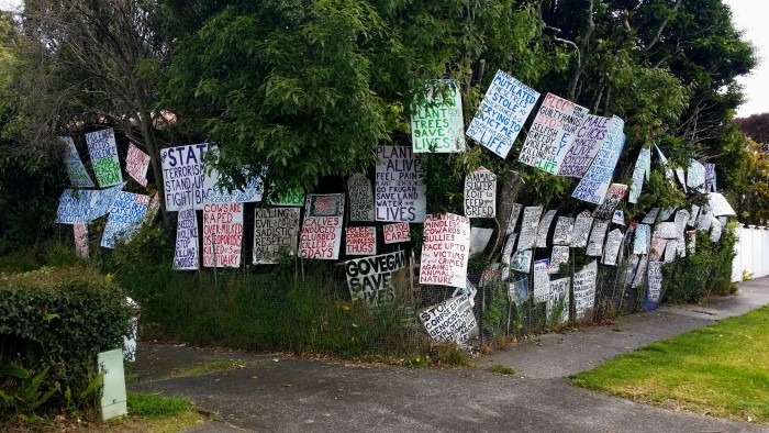 Protest placards in front of trees