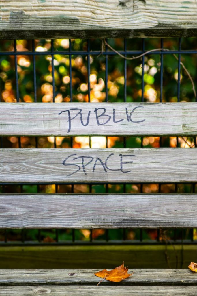 A fence painted with the slogan public space