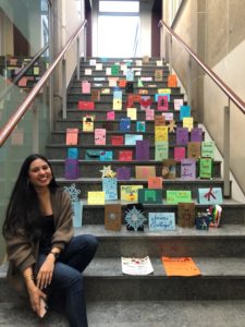 iSchool intern Sabrina Macklai with some of the holiday cards before they were sent to a local senior residence.