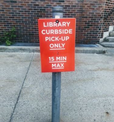 Carleton University Red Sign For Curbside Pickup Parking