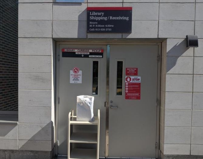 Service entrance to the Carleton University Library with self and white bag for curbside pickup