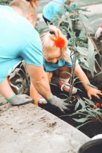 Father and daughter gardening together.