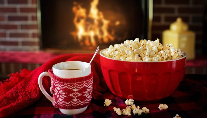 Hot Drink And Popcorn On A Table, In Front Of A Fire