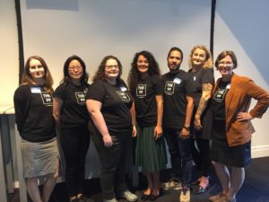 picture of seven smiling people standing in a row