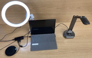 A streaming setup from the top including a ring light, laptop and a document camera